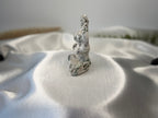 Treasured Energies tree agate crystal carving of a woman in a yoga pose with white and green dendritic patterns