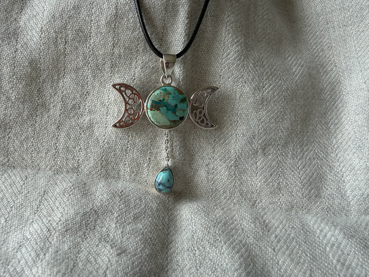 Treasured Energies Triple Moon pendant necklace with a turquoise stone and dangling teardrop on a black cord