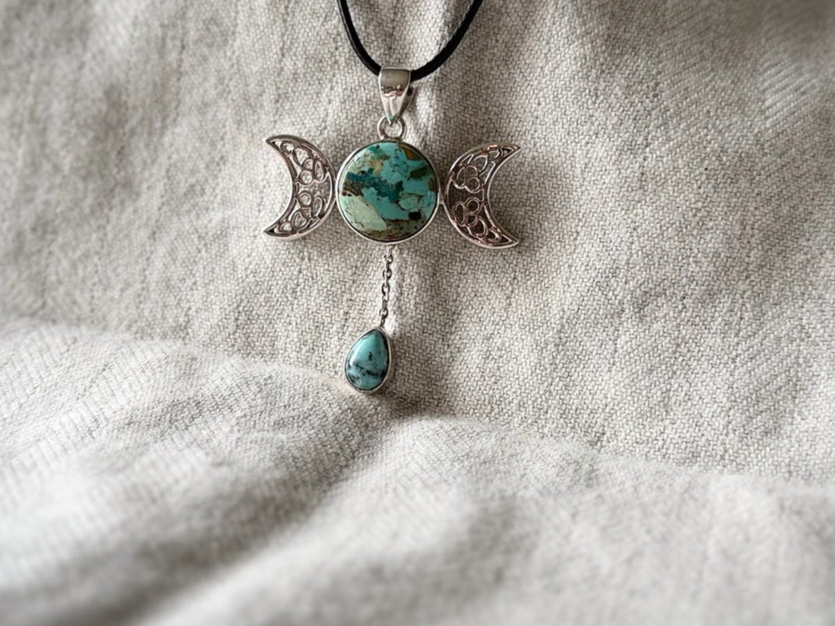 Treasured Energies Triple Moon pendant necklace with turquoise stone and dangling teardrop on a black cord