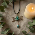 Treasured Energies Triple Moon Goddess pendant necklace featuring a turquoise stone on a black cord.