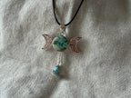 Treasured Energies Triple Moon pendant necklace with turquoise stones and silver-tone filigree on a black cord