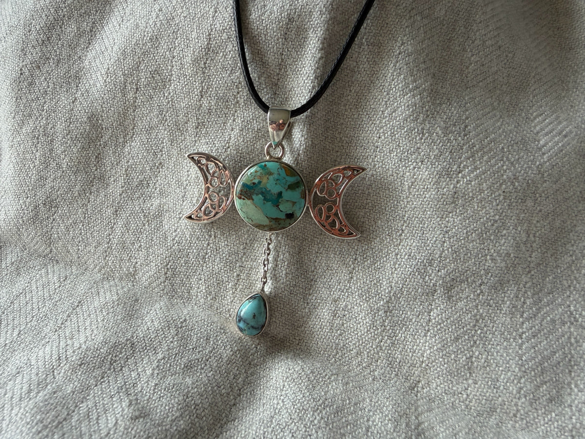 Treasured Energies Triple Moon pendant necklace with turquoise stones and silver-tone filigree on a black cord