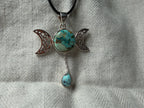Treasured Energies Triple Moon Goddess pendant necklace featuring a turquoise stone on a black cord.