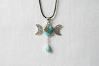 Treasured Energies triple moon goddess pendant necklace featuring a round turquoise stone and a dangling teardrop gem.