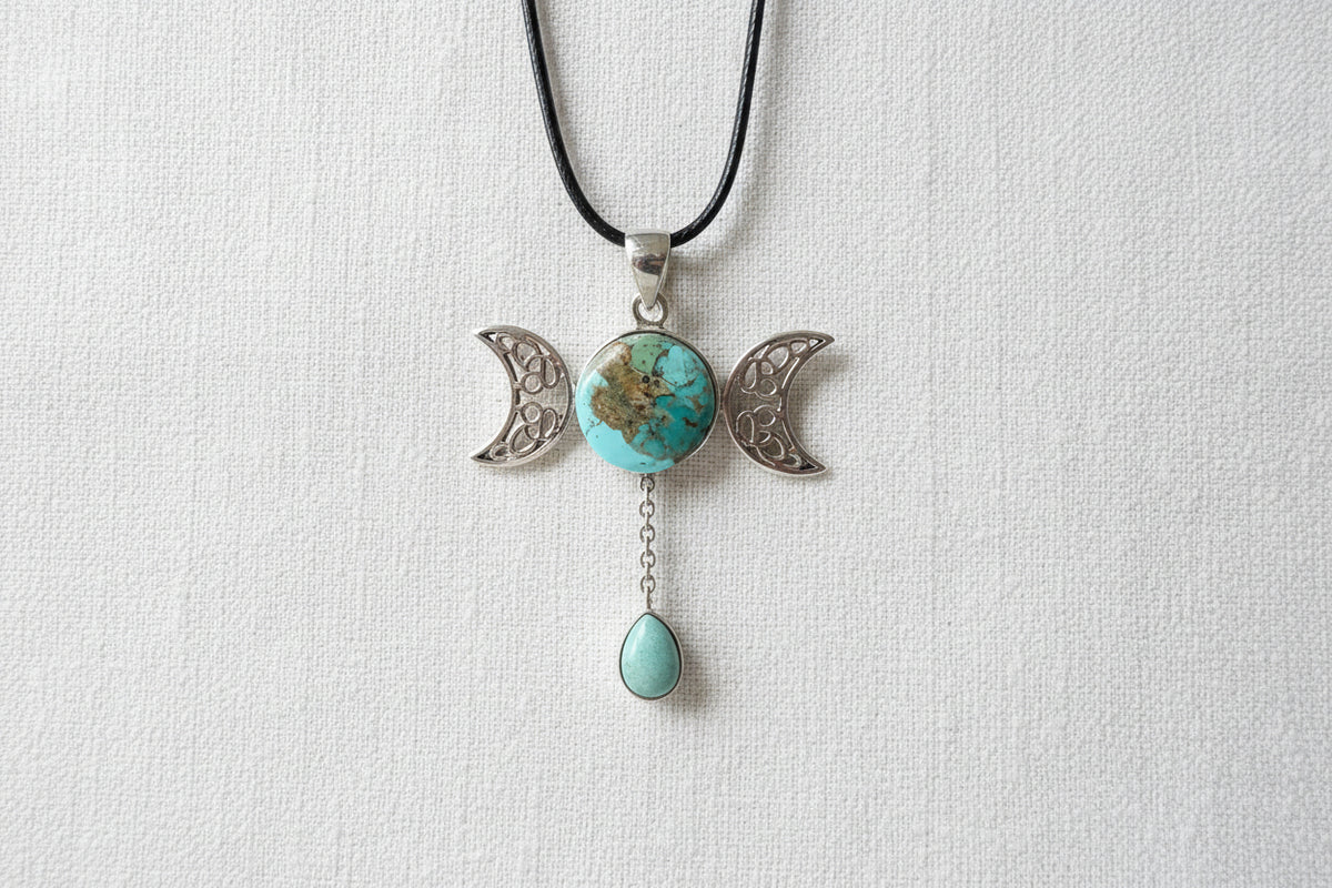 Treasured Energies triple moon goddess pendant necklace featuring a round turquoise stone and a dangling teardrop gem.
