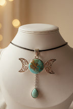 Treasured Energies turquoise triple moon goddess pendant necklace with silver filigree and a dangling teardrop stone.