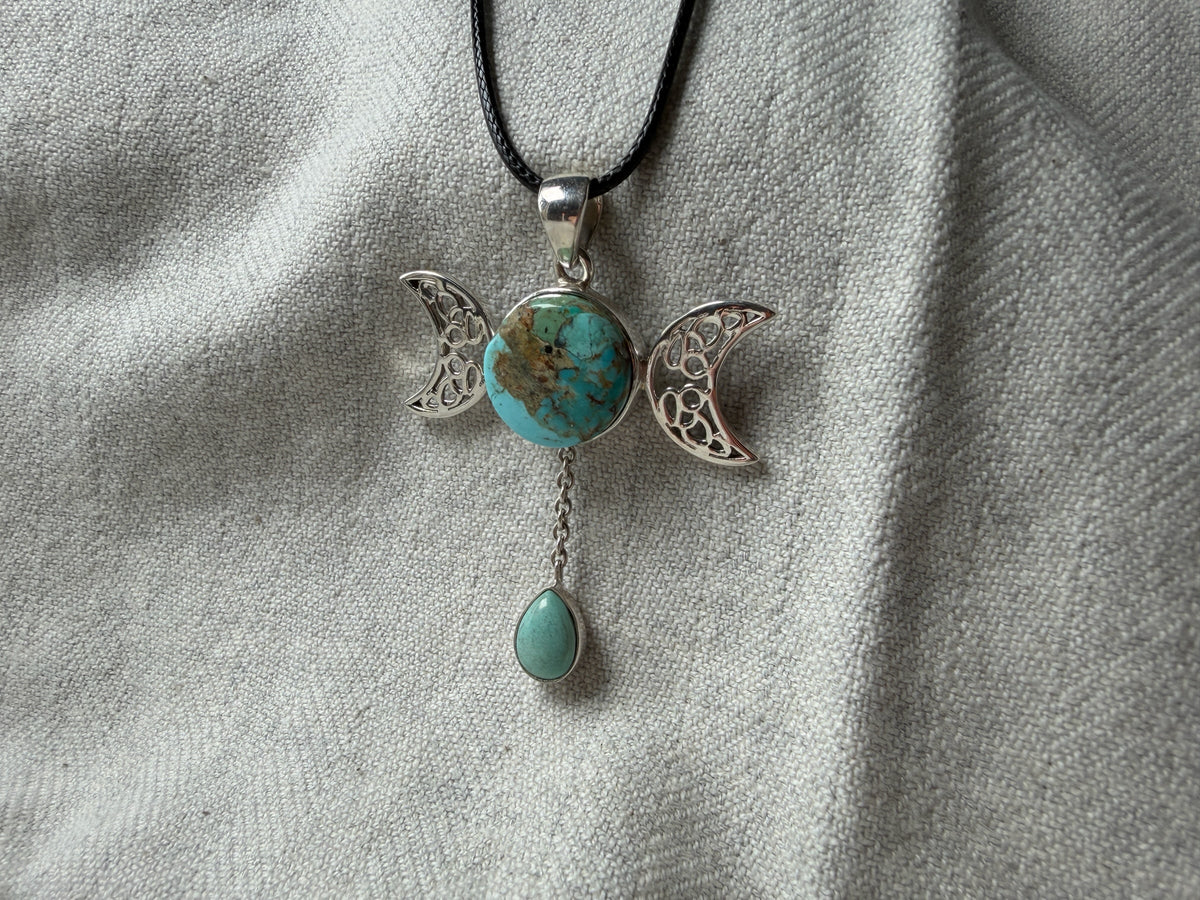 Treasured Energies triple moon goddess pendant necklace featuring a round turquoise stone and a dangling teardrop gem.