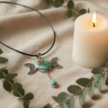 Treasured Energies turquoise triple moon goddess pendant necklace with silver filigree on a black cord