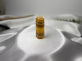 Treasured Energies yellow fluorite crystal tower with banded golden layers on a white satin background.