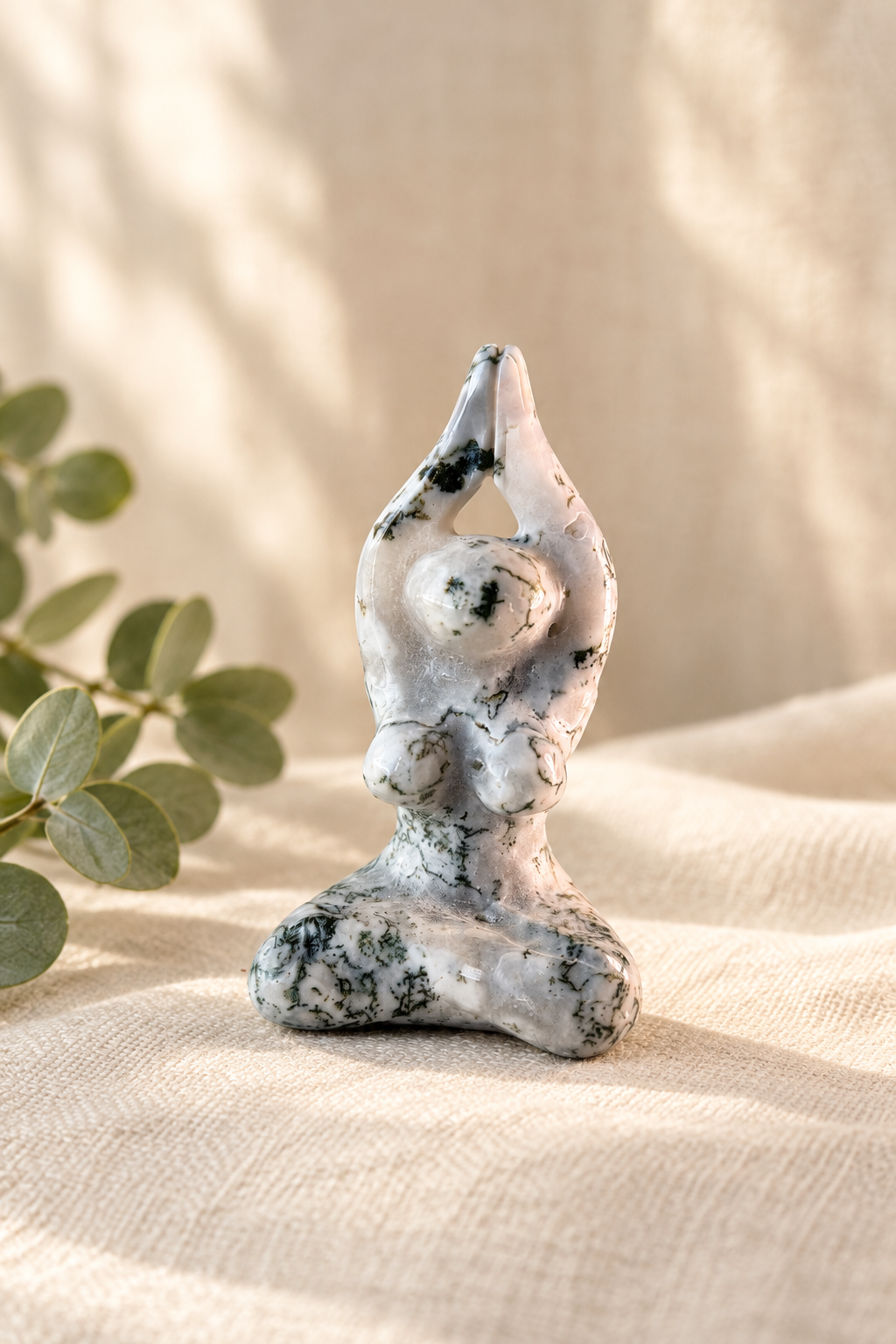 Warm linen lifestyle image of the tree agate goddess figurine